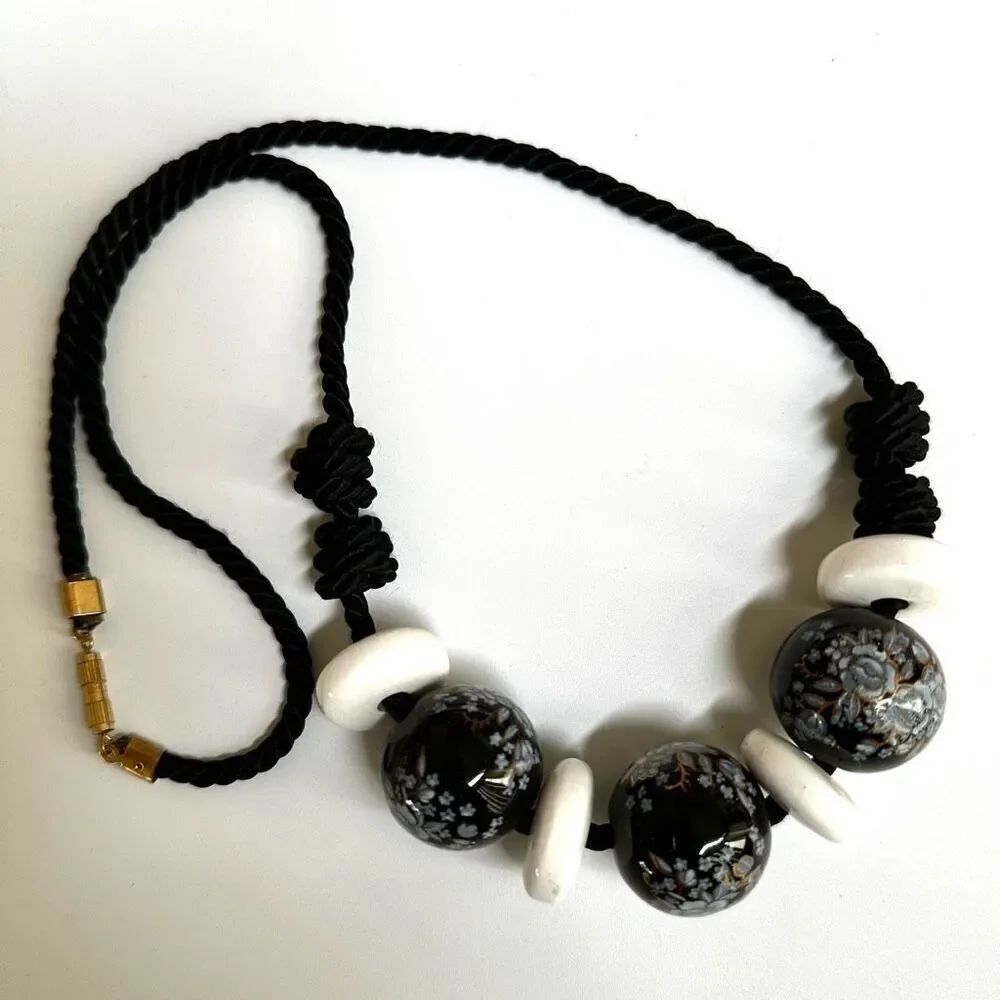 Black floral  and white beaded necklace on black cord